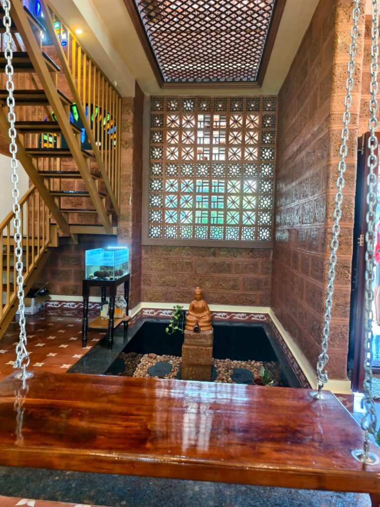 Traditional Kerala courtyard with swing and natural daylight